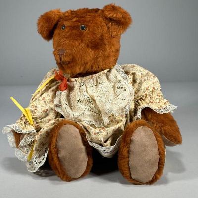 Early Plush Bear | Densely stuffed teddy bear in a floral patterned dress, with no apparent tag or label - w. 15 x h. 17 in

