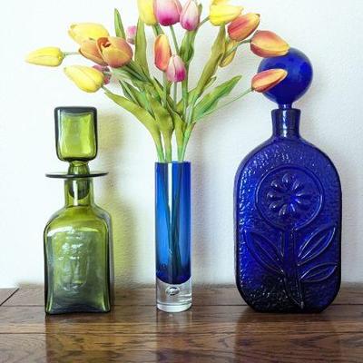 Lot #115 - Mid Century Blenko Wayne Husted Decanter, Green Glass Decanter, & Blue Glass Vase With Faux Tulips