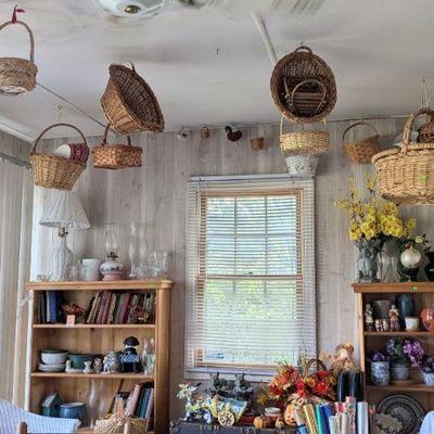 This porch is full of baskets, many hanging from the ceiling!
