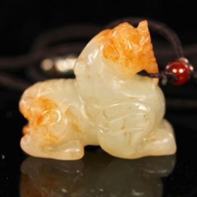 Carved jade foo dog pendant