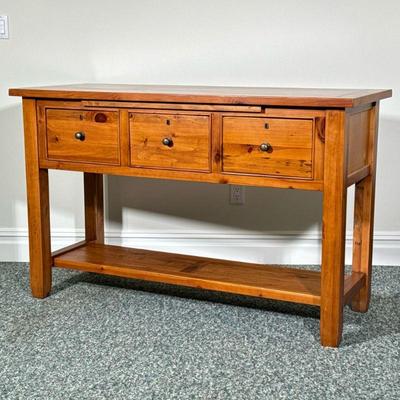 Pine Work Table | Having three large drawers beneath a slide-out surface, over a medial shelf. - l. 59 x w. 23 x h. 36.75 in

