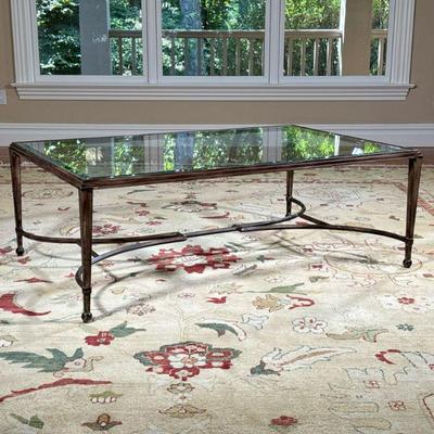 Metal Frame Low Table | Coffee table having a beveled glass top over a bronzed metal frame with shaped stretcher. - l. 54 x w. 36 x h....