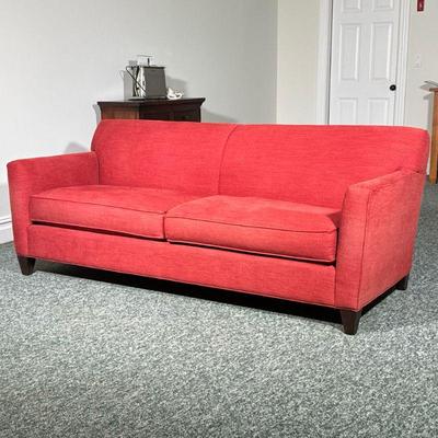 Crate & Barrel Red Sofa | With overall red textured upholstery, on dark wood tapered feet, having two seat cushions. - l. 81 x w. 33...