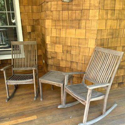 (3pc) TEAK WOOD OUTDOOR ROCKING CHAIR SET | Comprising two wood rocking chairs with slatted seats and backrests and a matching side table...