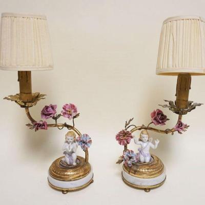 1049	PAIR OF PORCELAIN FIGURAL TABLE LAMPS ON MARBLE BASES W/IMAGES OF WINGED CHERUBS & FLOWERS, EACH APPROXIMATELY 15 IN HIGH OVERALL
