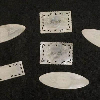 1111	GROUP OF ANTIQUE MOTHER OF PEARL CARVED PLACE HOLDERS, LARGEST APPROXIMATELY 2 1/2 X 1 IN
