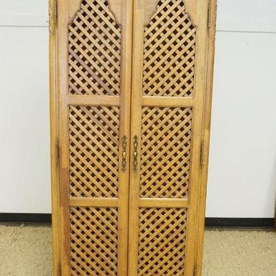 1230	FRENCH PROVENCIAL STYLE 2 DOOR CABINET WITH CARVED CREST AND LATTICE WORK PANELED DOORS, APPROXIMATELY 36 IN X 18 IN X 81 IN H
