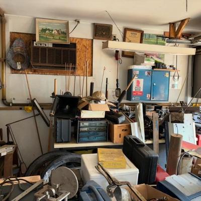 Piles of miscellaneous tools, piles of tractor parts, vintage tractor decals
