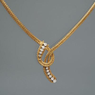 DIAMOND & 18K GOLD ITALIAN NECKLACE | Designed as a double snake chain with a conforming "knot" mounting ten graduated...