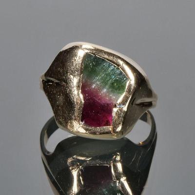BI-COLOR TOURMALINE & 14K GOLD RING | Designed as a natural amorphous bicolor tourmaline (showing green, a stripe of white, and...