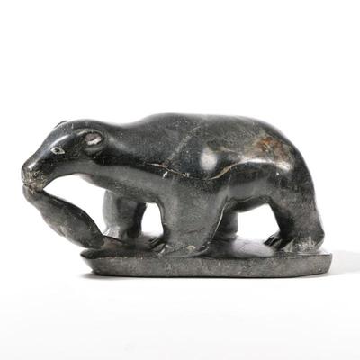 INUIT CARVED STONE BEAR | Carved stone figure of a bear with Canada Eskimo Art and Povungnituk label identifying artist on bottom - l. 11...