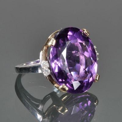 OVAL CUT AMETHYST, DIAMOND & 14K GOLD RING | Designed as a central oval mixed cut amethyst (22 x 17.1 x 10.8mm) prong-set in a yellow...