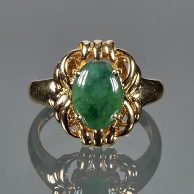 JADEITE CABOCHON & 18K GOLD RING | Designed as a central jade cabochon (10 x 7.4 in.) With gold backing in an 18 karat gold open...