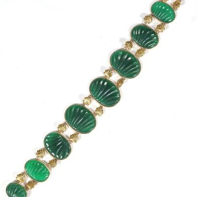 CARVED SPINACH JADE & 14K GOLD BRACELET | Designed as 8 links of oval shell-pattern carved jade plaques (23 x 17 mm, largest) mounted...