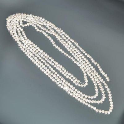 VERY LONG STRANDS OF BAROQUE PEARLS | Designed as a very long knotted strand of (approx. 6.5mm) baroque white pearls; 104 in.

