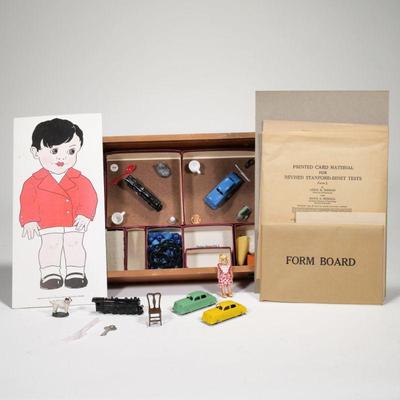 STANFORD-BINET COMPLETE TEST MATERIAL | By Lewis Terman and Maud A. Merrill, in a wooden fitted box - l. 15 x w. 10.5 x h. 3 in. (box)

