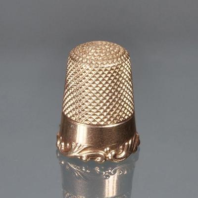ANTIQUE 14K GOLD THIMBLE | 14k yellow gold thimble with scrolling acanthus rim, with maker's mark or monogram and 14k fineness mark...