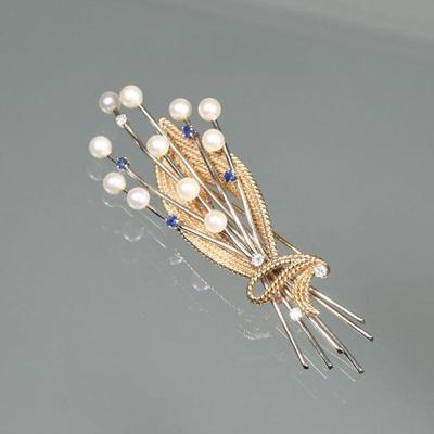 PEARL, SAPPHIRE, DIAMOND, & 14K GOLD BROOCH | Designed as 14 karat white gold sprays mounting 11 round pearls for small sapphires and...