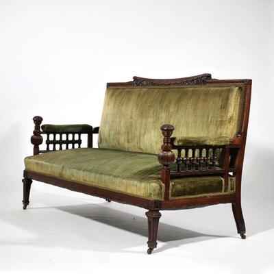 AESTHETIC PERIOD ROSEWOOD SETTEE | Late 19th century, profusedly carved and decorated; the crest rail with a central incurved section...