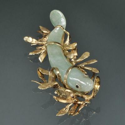 CARVED JADE FISH & 14K GOLD MOUNTED PENDANT | Designed as a carved jade fish set in a 14k yellow gold kelpy / seaweed-form setting;...