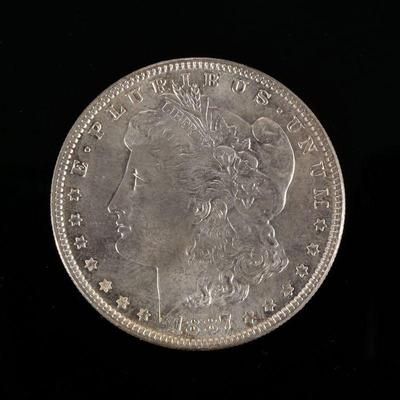 1887-P MORGAN SILVER DOLLAR | In a folding envelope describing it as "borderline MS 65"


