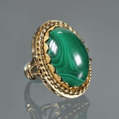 MALACHITE CABOCHON & 14K GOLD RING | Designed as a central solid polished oval malachite (20.5 x 15 x 8.1mm) set in a 14k yellow gold...