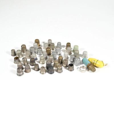 COLLECTION STERLING & OTHER THIMBLES | A collection of antique and later thimbles, including five sterling silver thimbles with...