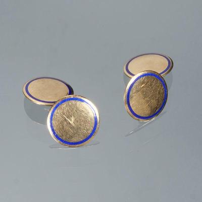 PAIR BLUE ENAMEL & 14K GOLD CUFFLINKS | Designed as polish round gold cufflinks each set with a border of blue enamel; 3/8 in. 9.1g...
