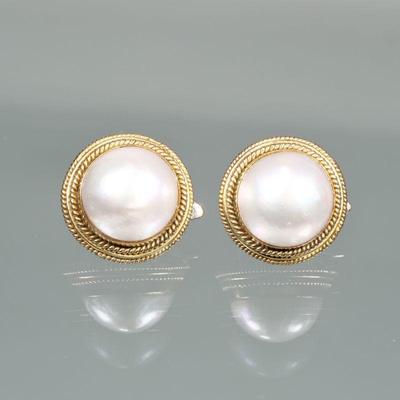 PAIR PEARL & 14K GOLD EARRINGS | Designed as central large half pearls (dia. 15mm) set in 14 karat gold surrounds with ear clips;...
