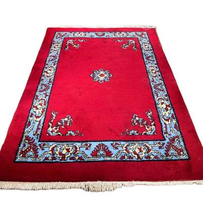 RED VINTAGE MOROCCAN RUG | Deep red color with a cerulean blue inner border. Tag reads "Morocco." - l. 106 x w. 74 in.

