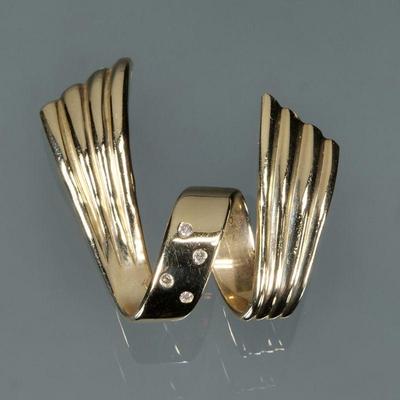 DIAMOND & 14K GOLD SPIRAL MOUNTING | Four melee diamonds set in a 14k yellow gold spiral ribbon-form mounting, with fineness mark;...