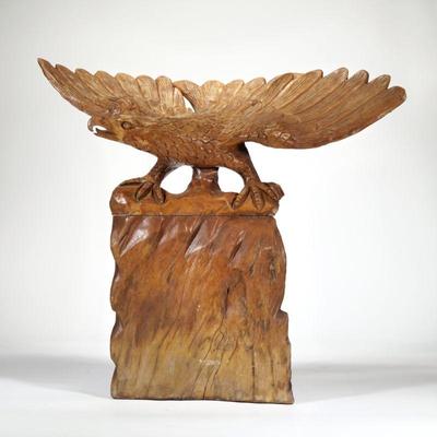 FOLK ART EAGLE WOOD CARVING | Carved wood sculpture of an eagle perched on a rock formation, no apparent signature. - l. 31 x w. 11.5 x...