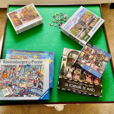 Lot 046-B: Puzzle Board & Puzzles Galore

Features: 
•	A treasure trove for the jigsaw puzzler (aka “Dissectologist”)
•	Includes a...
