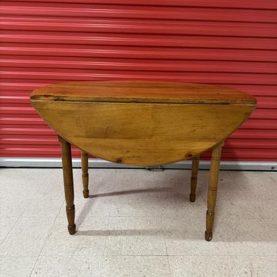 Antique pine, round, drop leaf table. Well made and sturdy with handsomely crafted legs. This versatile table could be purposed as a...