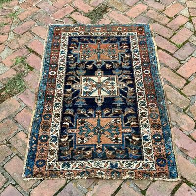 Antique geometric hand knotted wool  oriental carpet. Measures 50” x 34”. 