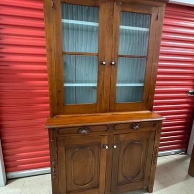 Fine antique Jackson Press featuring glass fronts, three interior shelves in the top and a shelf in the bottom cabinet. Lovely pale blue...