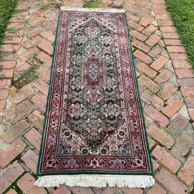 Vintage hand knotted wool runner carpet. Measures 71” x 30”. 