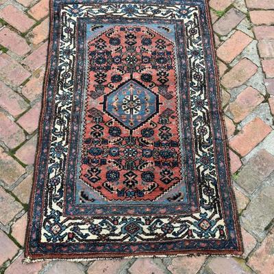 Antique hand knotted wool oriental carpet in geometric design. Measures 54” x 32 1/2”
 .