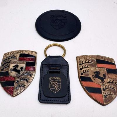 (2) Vintage Porsche Hood Crests, (1) Porsche Wheel Center Cap & (1) Porsche Crest Keychain
