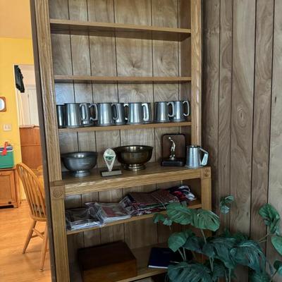Bookshelf, pewter mugs, bowls