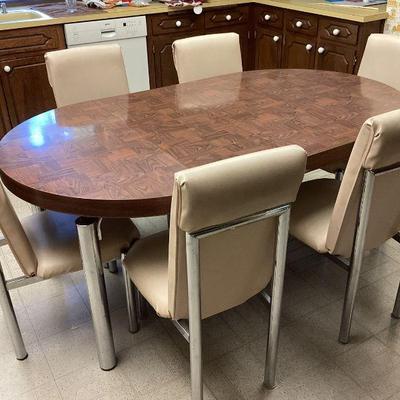JEHA714 Mid Century Dining Room Table W/Chrome Frame	Seats six but has two additional leaves. Leaves measure 14.5 inches each. When set...