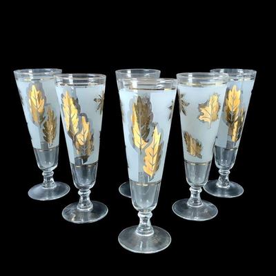 DEJE211 Vintage Gold Leaf Pilsner Glasses	6 Frosted Gold Leaf Pilsner Glasses. One of the glasses shows a little wear on the gold leaf. 
