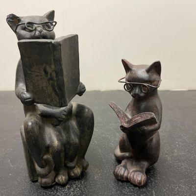 Cats reading carved