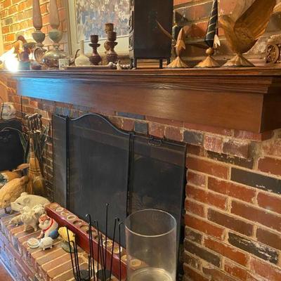 Fireplace decorated with unique items including a Fireplace screen