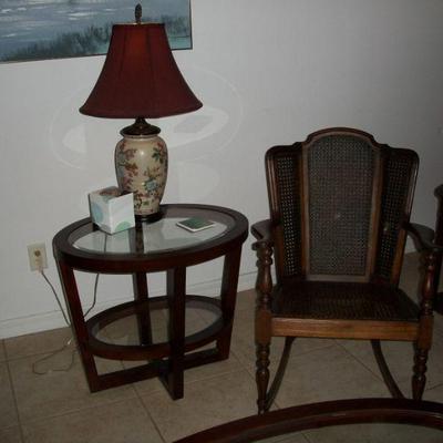 Antique/Vintage HZM & Co. Caned Seat 7 Back Rocker ; Wood Oval End Table with 2 - glass inserts ; Table Lamp.