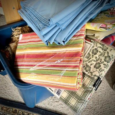 Pine armoire filled with linens (tablecloths, runners, napkins, and placemats) and fabric remnants