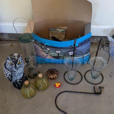 Lot #B193 - Garden Decor and Accessories Lot - Solar Lights, Bird Feeders, Owl Statue, & More