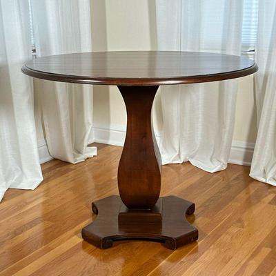 ROUND PEDESTAL TABLE | Having circular wood top over carved pedestal base. - h. 31 x dia. 39 in

