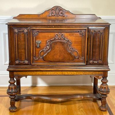 ANTIQUE CARVED WOOD BUFFET | Having carved backboard over relief carved cabinet with large door with spindle carved & fluted legs. -...