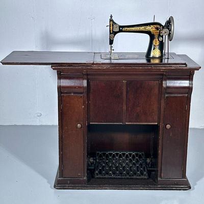 ANTIQUE STENCILED SINGER SEWING MACHINE & CABINET | Early 20th century Singer sewing machine & cabinet with multiple drawers,...